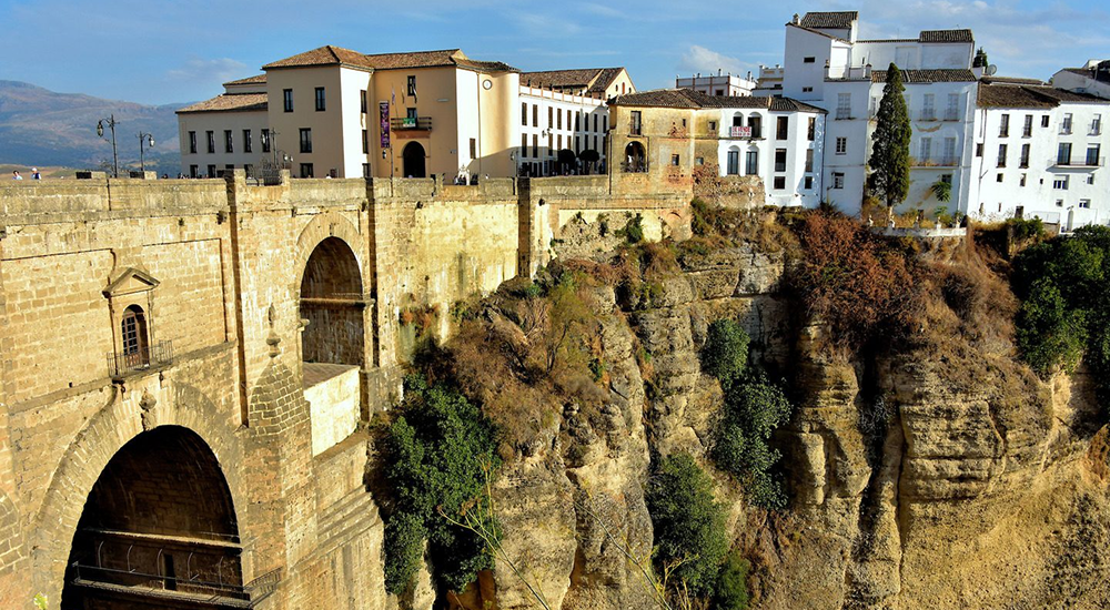 Perched dramatically on the edge of a deep gorge, Ronda is a stunning town in the Andalusian region of Spain